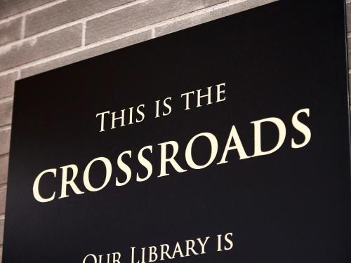 a sign that reads this is the crosses our library is at IN THE LIBRARY hotel and books TOKOROZAWA - Opening in 15th July 2025 in Tokorozawa
