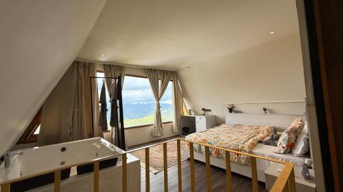 a bedroom with a bed and a large window at Himadvaya- The Himalayan Prism in Almora