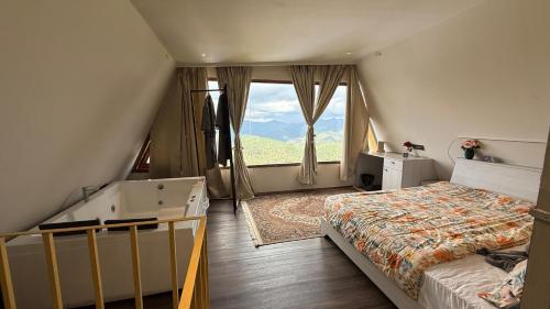 a bedroom with a bed and a large window at Himadvaya- The Himalayan Prism in Almora