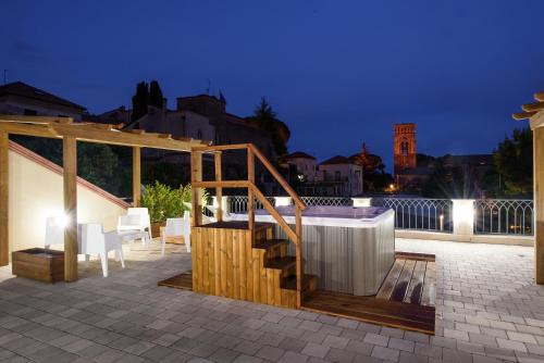 a patio with a staircase and a table and chairs at Ravello House in Ravello