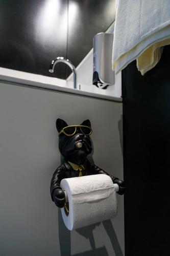 a toilet paper dispenser with a bear wearing glasses at SEE - Gare de Marly in Valenciennes