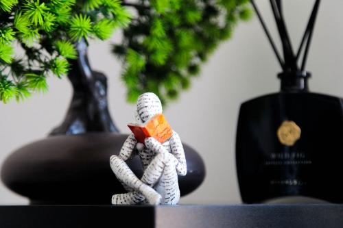 a small rope toy sitting on a table with a plant at SEE - Gare de Marly in Valenciennes