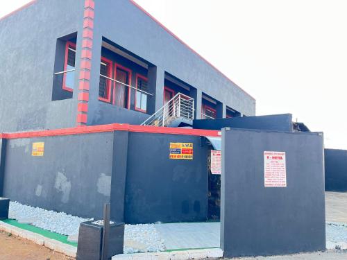 a blue building with a door in front of it at X-Motel Voslo in Johannesburg