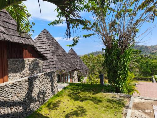 a row of houses with a stone wall at Golo Pada Villa Labuan Bajo by ABM in Nggorang