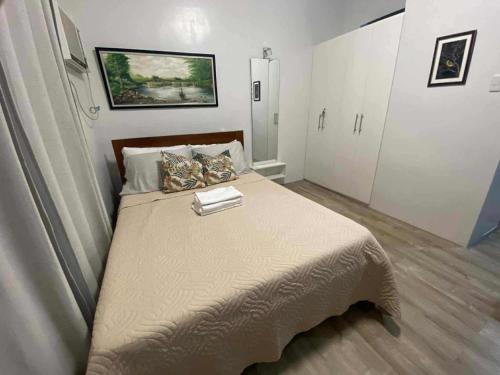 a bedroom with a large bed in a room at Isabela III, Mesavirre Garden Residences in Bacolod