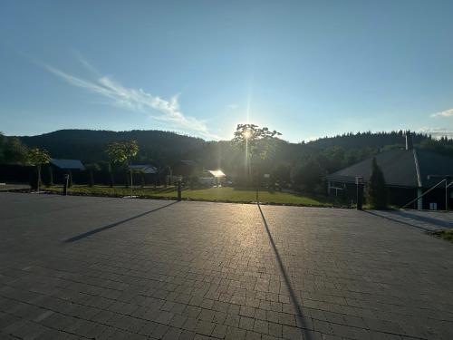 an empty parking lot with the sun in the background at Краєвид in Slavske