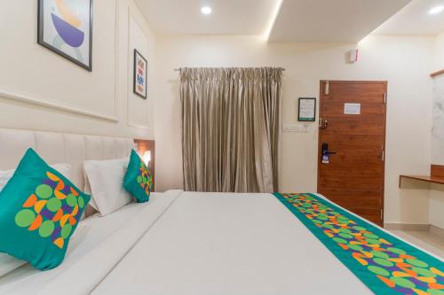 a bedroom with a white bed and a window at Treebo Memories Inn in Bengaluru