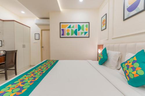 a bedroom with a white bed and a desk at Treebo Memories Inn in Bengaluru