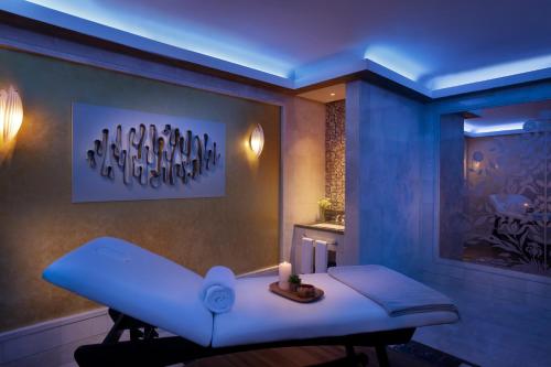 a blue room with a table with a candle on it at Makkah Clock Royal Tower, A Fairmont Hotel in Makkah