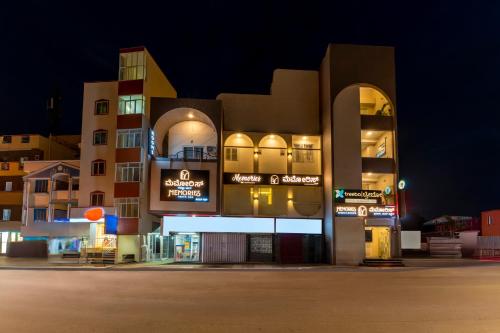 a building at night with a parking lot in front at Treebo Memories Inn in Bengaluru