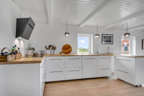 a kitchen with white cabinets and a counter top at 526-Lemvig-Rubyvej-21 in Lemvig
