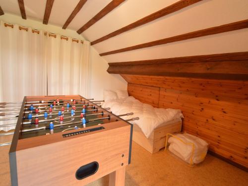 a room with a foosball table in front of a bed at Ardennes villa with riverside garden and views in Saint-Vith