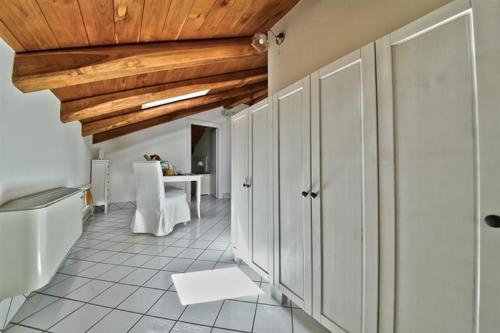 eine Küche mit weißen Schränken und einer Holzdecke in der Unterkunft Palazzo Dogana Rooms in Agropoli