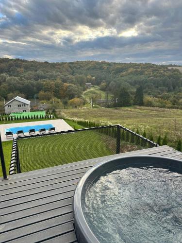 a hot tub sitting on top of a deck at Lav inn Polyana Затишок in Polyana