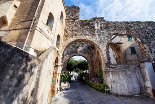 an old building with an archway in a street at Ravello House in Ravello