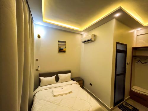 a small room with a bed in it at GEMSON HOMEs in Dar es Salaam