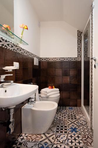 a bathroom with a white sink and a toilet at Ravello House in Ravello