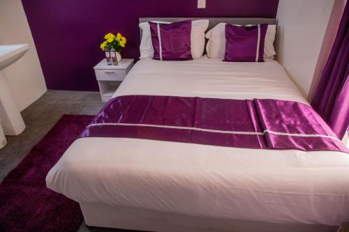 Ένα ή περισσότερα κρεβάτια σε δωμάτιο στο Nyams Boutique Hotel