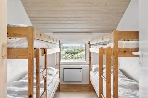 two bunk beds in a room with a window at 302-Harboore-Fourmivej-74 in Harboør
