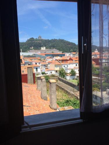 una ventana con vistas a la ciudad en Private Room in Old Town, en Viana do Castelo