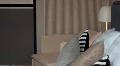 a living room with a couch with pillows on it at Hotel Zamburger Bentong in Bentong
