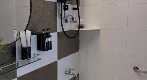 a shower in a bathroom with a hose at Hotel Zamburger Bentong in Bentong