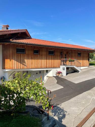 a large building with a ramp and a porch at Das DolomitenNest in Dölsach