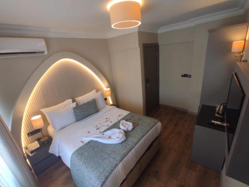 a bedroom with a large bed with a stuffed animal on it at Mara Oldcity Hotel in Istanbul