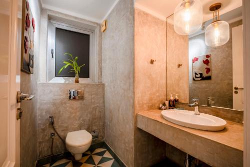 a bathroom with a sink and a toilet at HideAway 2BHK Duplex Villa, North Goa (STU) in Mapusa