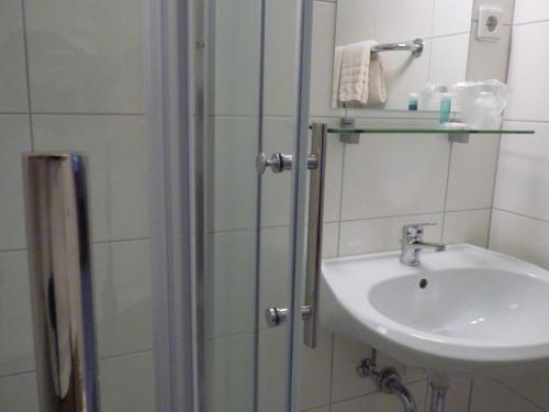 a bathroom with a sink and a shower at Hotel Diele in Detmold