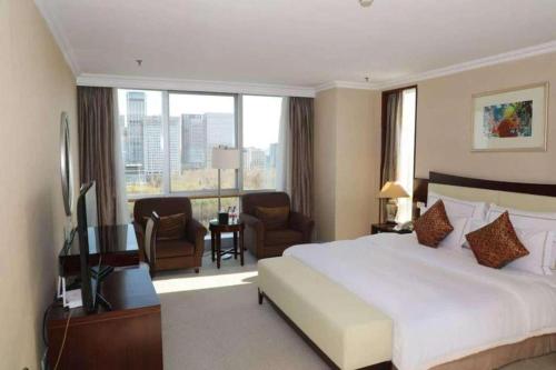 Postel nebo postele na pokoji v ubytování Beijing Jinjiang Fuyuan Hotel