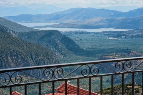 a view of a valley from a balcony at Hotel Lefas in Delphi