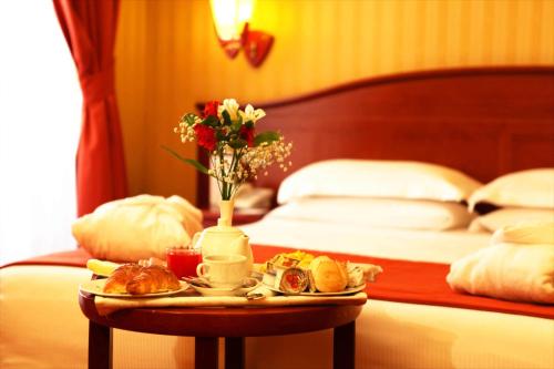 a tray of food on a table in a hotel room at Augusta Lucilla Palace in Rome