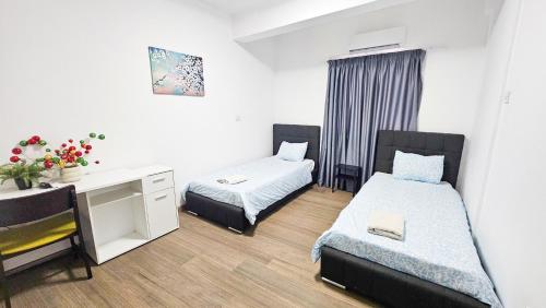 a small room with two beds and a desk at Downtown Rooms, 200m from Marina Beach in Larnaka