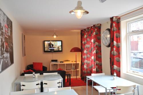 a dining room with white tables and white chairs at The Bunkroom in Chester