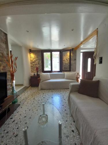 a living room with a couch and a table at Με θέα το Αιγαίο in Agia Marina Lesvos