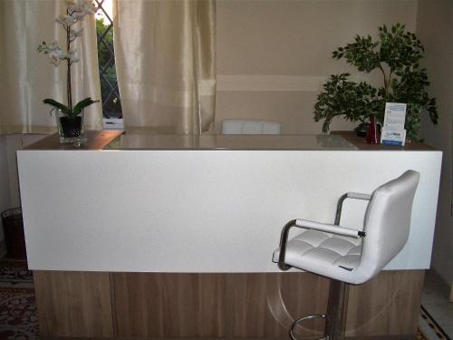 a white counter with a chair in a room at Lucca Relais in Lucca