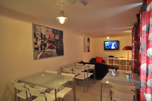 a restaurant with tables and chairs and a tv at The Bunkroom in Chester