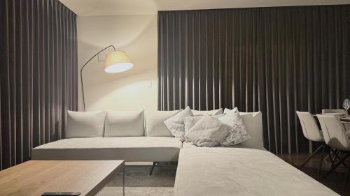 a bedroom with a bed and a couch and a table at Villa Hilala Miyakojima in Miyako Island