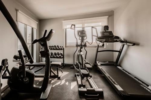 a gym with two exercise bikes and a treadmill at Spinola Hotel in St Julian's