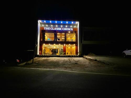 a building with a sign that reads theassociate room at Hotel Classic Crown - #scenic mountain view #open terrace #parking #premium rooms with balcony #guest preferred #best selling hotel in mussoorie in Mussoorie
