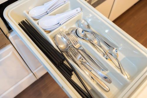 a tray of silver utensils in a drawer at yah homes takasago in Fukuoka