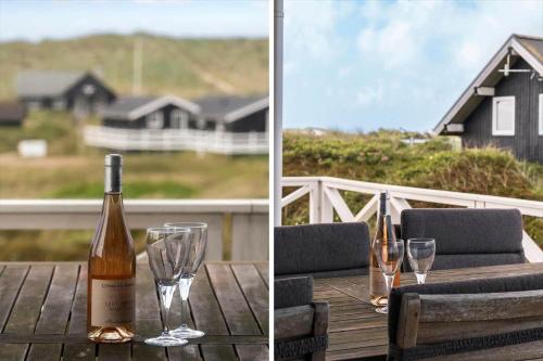 a bottle of wine sitting on a table with glasses at 218-Harboore-Dalevej-6-a in Harboør