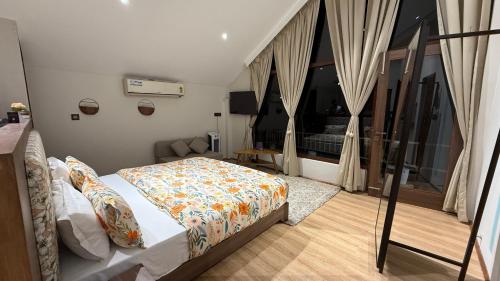 a bedroom with a bed and a large window at Himadvaya- The Himalayan Prism in Almora