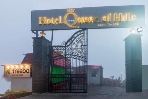 a hotel queen of hills sign in front of a gate at Treebo Premium Queen Of Hills Near Mall Road in Mussoorie