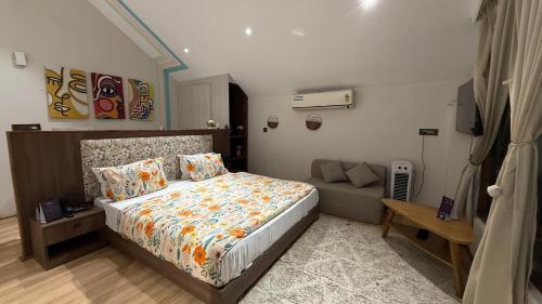 a bedroom with a bed and a couch at Himadvaya- The Himalayan Prism in Almora