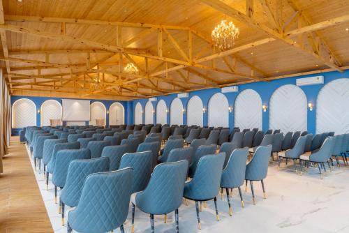 a row of chairs in a room with blue chairs at Treebo Premium Queen Of Hills Near Mall Road in Mussoorie