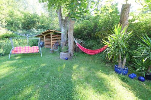 a hammock in a garden with a tree at Frauenpension Arleta - Women only in Goslar