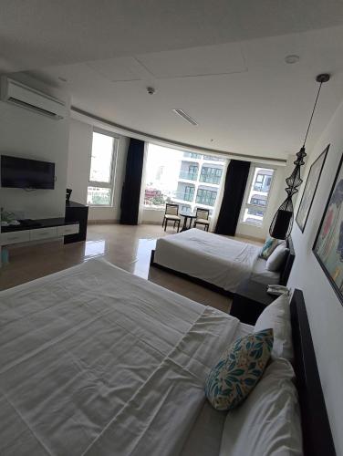 a hotel room with two beds and a television at Orchids Ocean Hotel in Da Nang