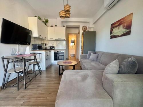 a living room with a couch and a table at Chloe Stay Complex by Horizon Homes in Orfánion